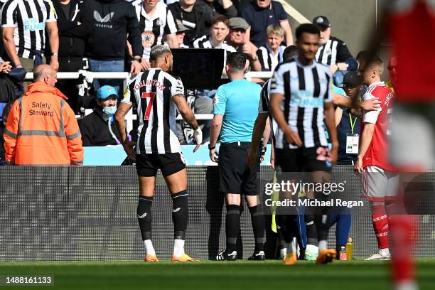 Referee Chris Kavanagh looks at a Monitor as they watch a VAR Review for a potential penalty during the Premier League match between Newcastle United...