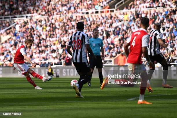Martin Odegaard of Arsenal scores the team's first goal during the Premier League match between Newcastle United and Arsenal FC at St. James Park on...