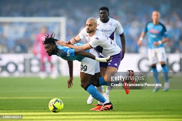 Andre-Frank Zambo Anguissa of SSC Napoli is challenged by Sofyan Amrabat of ACF Fiorentina during the Serie A match between SSC Napoli and ACF...