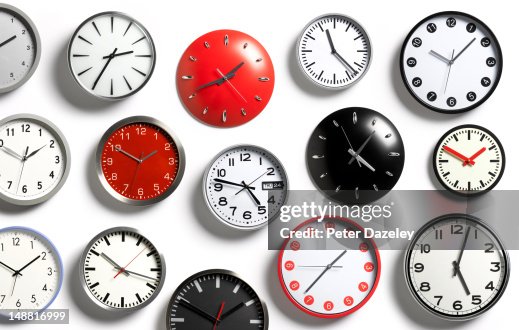 A selection of wall clocks showing different times A selection of wall clocks showing different times