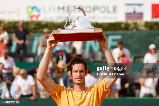 Andy Murray of Great Britain holds the trophy after beating Tommy Paul of the United States on Court Credit Agricole during the singles finals at the...