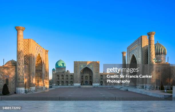 majestic registan square at dawn in samarkand, uzbekistan with "ulugh beg" madrasah (1417–1420) on the left, the "tilya-kori" madrasah in the center (1646–1660) and the "sher-dor" madrasah on the right, a unesco heritage site - silk road stock pictures, royalty-free photos & images