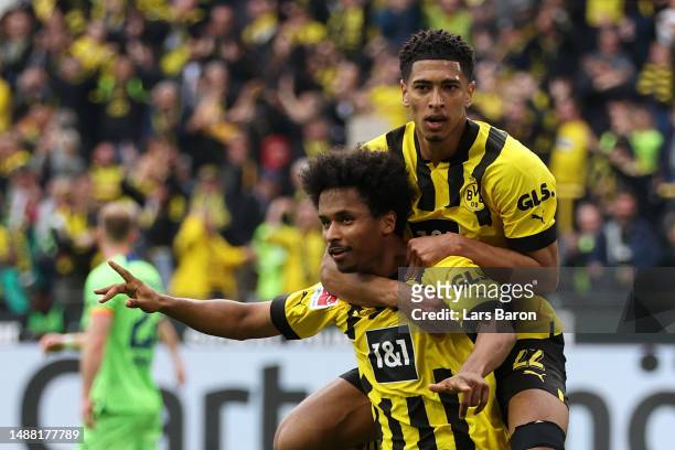 Karim Adeyemi of Borussia Dortmund celebrates with teammate Jude Bellingham after scoring the team's fifth goal during the Bundesliga match between...