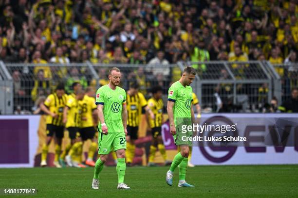 Maximilian Arnold and Mattias Svanberg of VfL Wolfsburg look dejected after Karim Adeyemi of Borussia Dortmund scores the team's fifth goal during...
