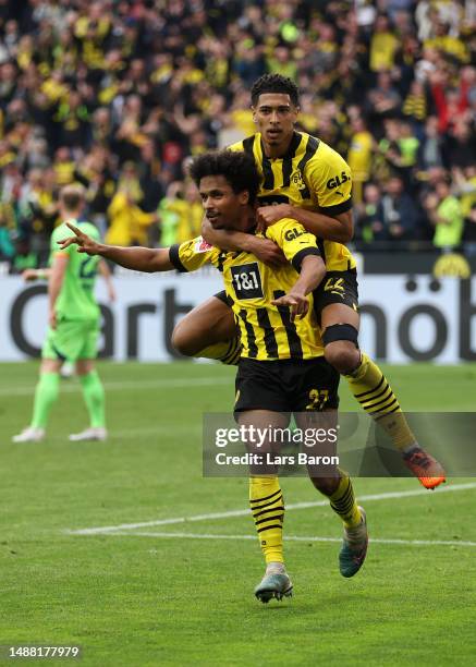 Karim Adeyemi of Borussia Dortmund celebrates with teammate Jude Bellingham after scoring the team's fifth goal during the Bundesliga match between...