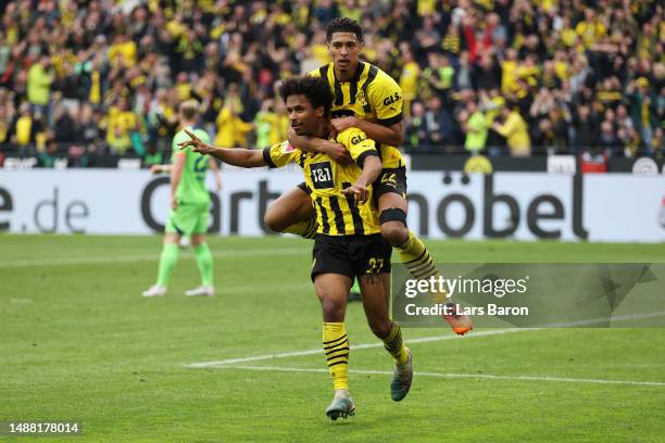 Karim Adeyemi of Borussia Dortmund celebrates with teammate Jude Bellingham after scoring the team's fifth goal during the Bundesliga match between...