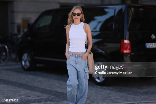 Marlies Pia Pfeifhofer seen wearing Saint Laurent black sunglasses, LeGer by Lena Gercke white tank top, Agolde light blue baggy low waist jeans,...