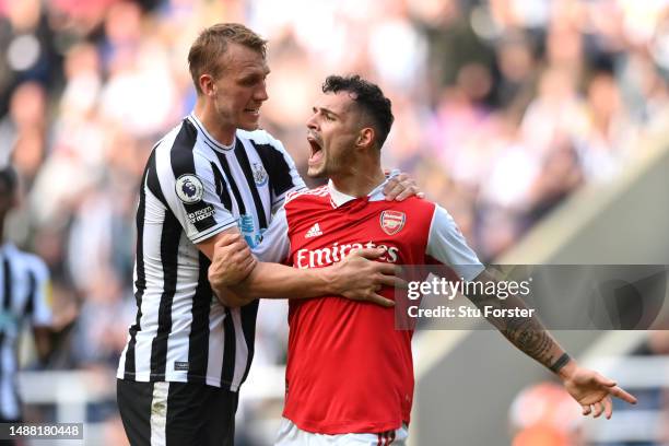 Dan Burn of Newcastle United speaks with Granit Xhaka of Arsenal during the Premier League match between Newcastle United and Arsenal FC at St. James...