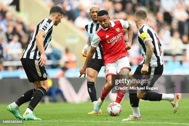 Gabriel Jesus of Arsenal passes the ball whilst under pressure during the Premier League match between Newcastle United and Arsenal FC at St. James...