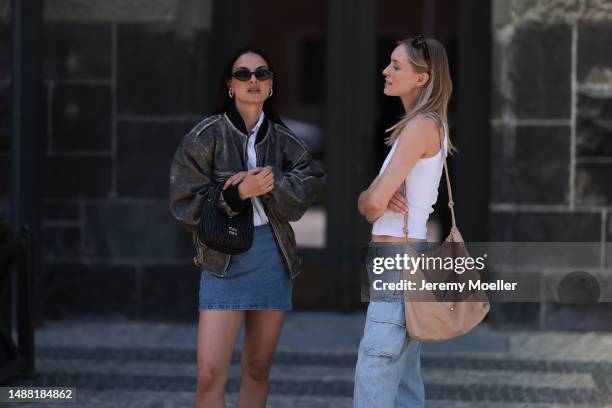 Anna Winter seen wearing Saint Laurent black sunglasses, silver earrings, Filippa K white button shirt, DUCIE London grey faded leather bomber...