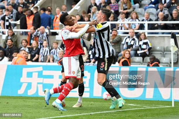 Eddie Nketiah of Arsenal and Fabian Schaer of Newcastle United clash during the Premier League match between Newcastle United and Arsenal FC at St....