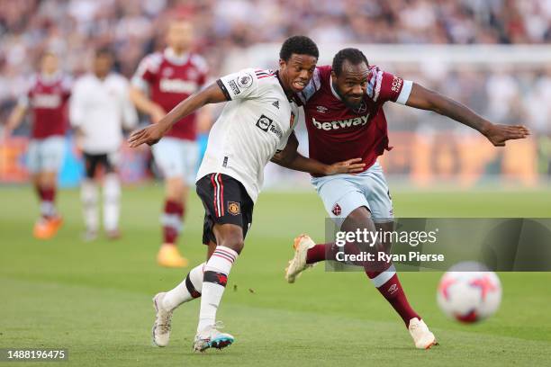 Michail Antonio of West Ham United battles for possession with Tyrell Malacia of Manchester United during the Premier League match between West Ham...