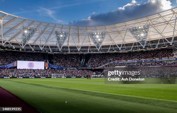 General view inside the stadium as both sides stand for the national anthem for the Coronation of Charles III and Camilla prior to the Premier League...