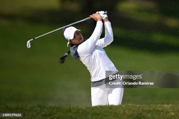 Patty Tavatanakit of Team Thailand plays her shot from a bunker on the 14th hole during day four of the Hanwha LIFEPLUS International Crown at TPC...