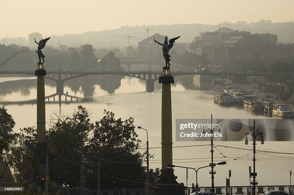 Vltava River and Legii most bridge with pillars and statues.