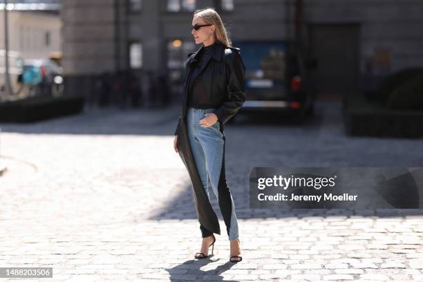 Marlies Pia Pfeifhofer seen wearing Saint Laurent black sunglasses, Mugler x H&M silver earrings, Mugler x H&M black stars print pattern transparent...