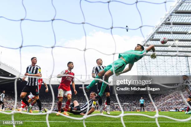 Nick Pope of Newcastle United attempts to make a save during the Premier League match between Newcastle United and Arsenal FC at St. James Park on...