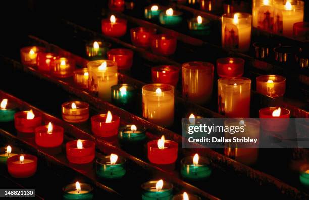 prayer candles burning in saint nazaire basilique of medieval walled city. - candles stock pictures, royalty-free photos & images