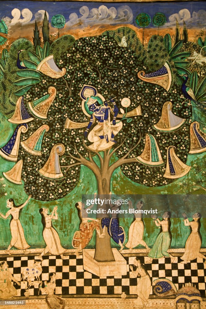 Mural of Krishna playing flute in tree with amorous gopis below, Chitrasala in Bundi Palace.