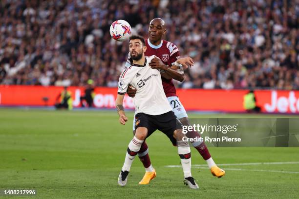 Bruno Fernandes of Manchester United is challenged by Angelo Ogbonna of West Ham United during the Premier League match between West Ham United and...