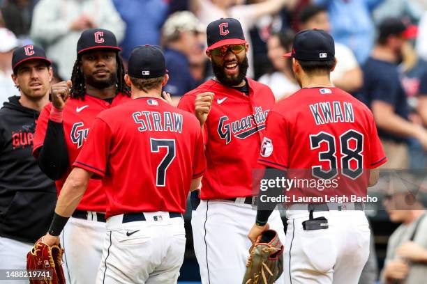 Amed Rosario of the Cleveland Guardians fist bumps his teammates after the Guardians beat the Minnesota Twins at Progressive Field on May 7, 2023 in...