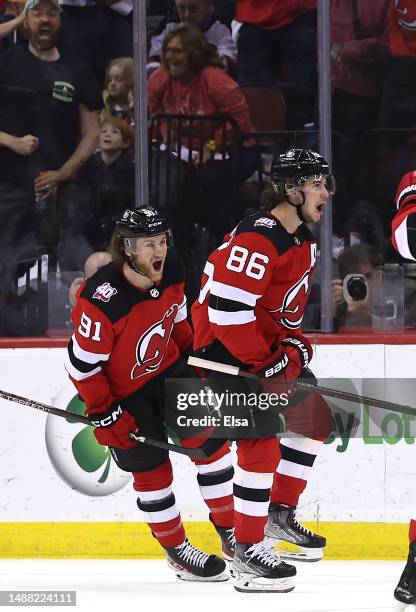 Jack Hughes of the New Jersey Devils celebrates his goal with teammate Dawson Mercer during the first period in Game Three of the Second Round of the...