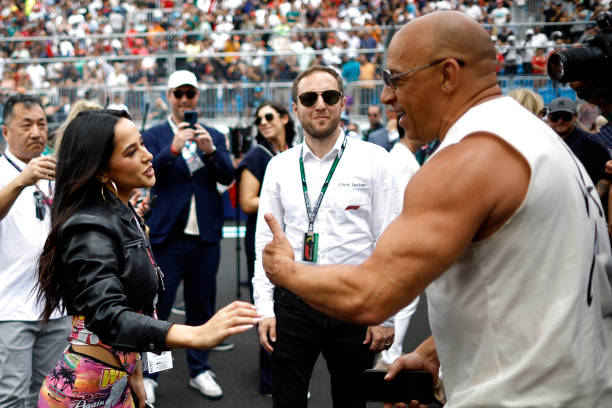 Vin Diesel talks with Becky G on the grid prior to the F1 Grand Prix of Miami at Miami International Autodrome on May 07, 2023 in Miami, Florida.