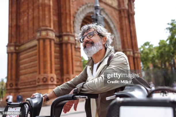 active senior using bicycle sharing system in the city - sharing economy 個照片及圖片檔