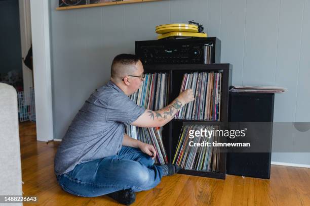 man with autism enjoying listening to records - disability collection stock pictures, royalty-free photos & images