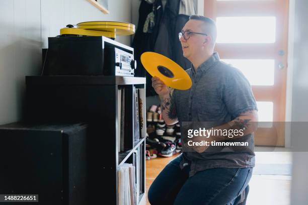 man with autism enjoying listening to records - personal stereo stockfoto's en -beelden