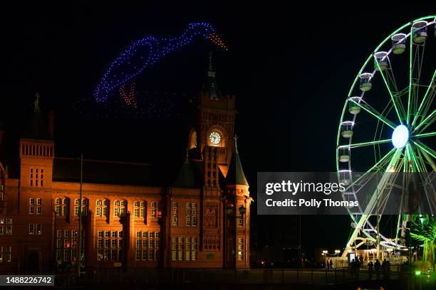 Drones fly in the shape of a heron over Roald Dahl Plass and the Wales Millenium Centre during the Coronation Concert on May 7, 2023 in Cardiff,...