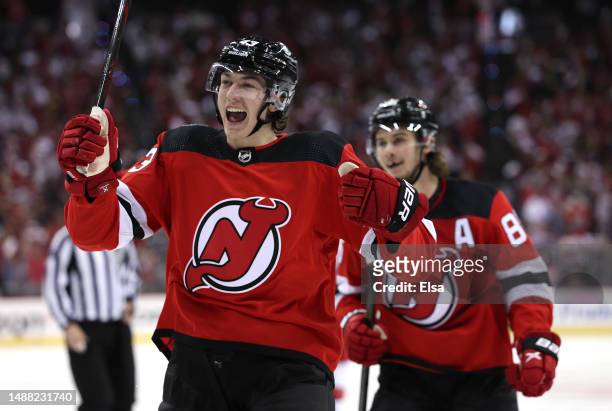 Jack Hughes and Luke Hughes of the New Jersey Devils celebrate teammate Damon Severson's goal during the second period in Game Three of the Second...