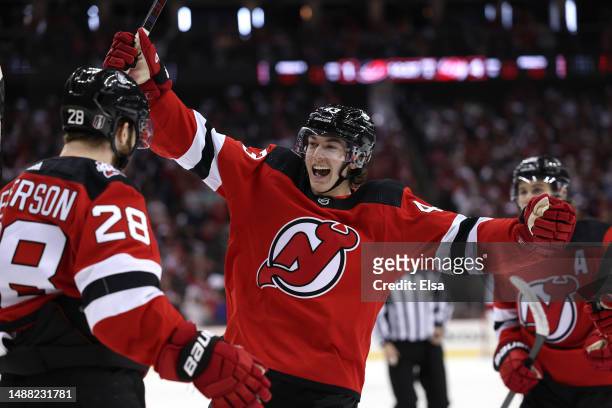 Damon Severson of the New Jersey Devils celebrates his goal with teammates Luke Hughes and Jack Hughes during the second period in Game Three of the...