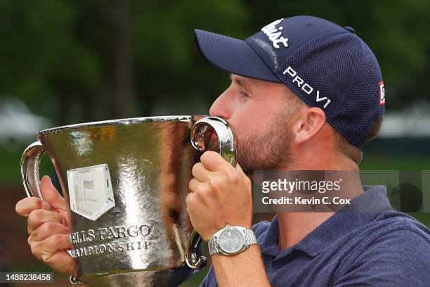 Wyndham Clark of the United States celebrates with the trophy during the trophy ceremony after winning during the final round of the Wells Fargo...
