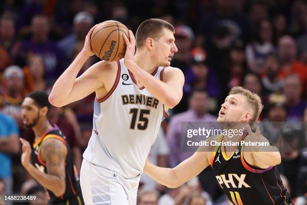 Nikola Jokic of the Denver Nuggets handles the ball against Jock Landale of the Phoenix Suns during Game Three of the NBA Western Conference...