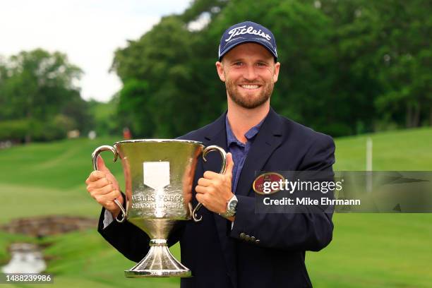 Wyndham Clark of the United States celebrates with the trophy after winning during the final round of the Wells Fargo Championship at Quail Hollow...