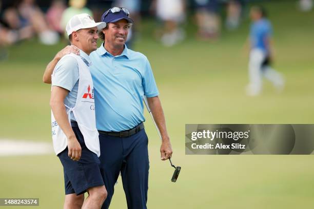 Stephen Ames of Canada celebrates with his son and caddie Ryan Ames after the final round of the Mitsubishi Electric Classic at TPC Sugarloaf Golf...