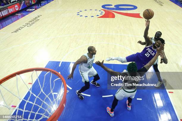 Joel Embiid of the Philadelphia 76ers shoots the ball against Marcus Smart of the Boston Celtics during the third quarter in game four of the Eastern...