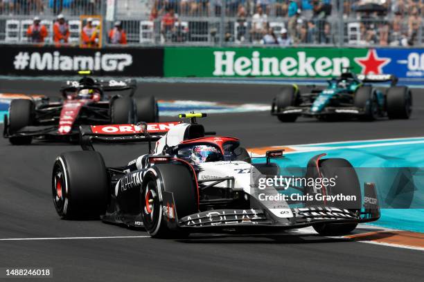 Yuki Tsunoda of Japan driving the Scuderia AlphaTauri AT04 leads Zhou Guanyu of China driving the Alfa Romeo F1 C43 Ferrari during the F1 Grand Prix...