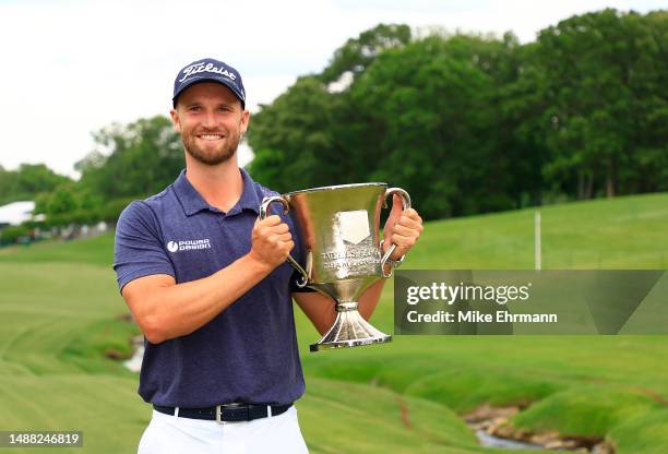 Wyndham Clark of the United States celebrates with the trophy after winning during the final round of the Wells Fargo Championship at Quail Hollow...