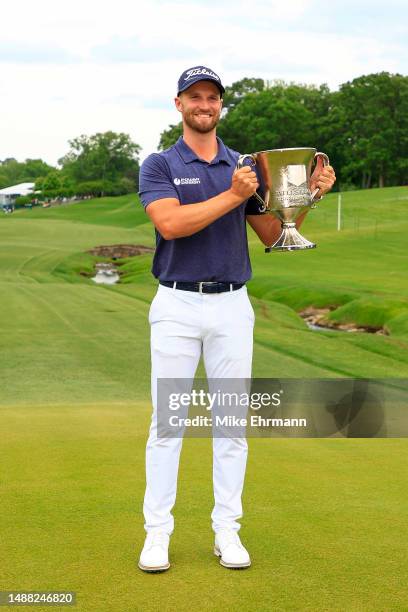 Wyndham Clark of the United States celebrates with the trophy after winning during the final round of the Wells Fargo Championship at Quail Hollow...