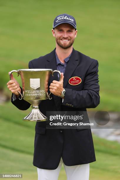 Wyndham Clark of the United States celebrates with the trophy after winning during the final round of the Wells Fargo Championship at Quail Hollow...