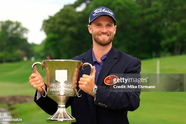 Wyndham Clark of the United States celebrates with the trophy after winning during the final round of the Wells Fargo Championship at Quail Hollow...