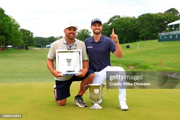 Wyndham Clark of the United States celebrates with the trophy alongside caddie John Ellis after winning during the final round of the Wells Fargo...
