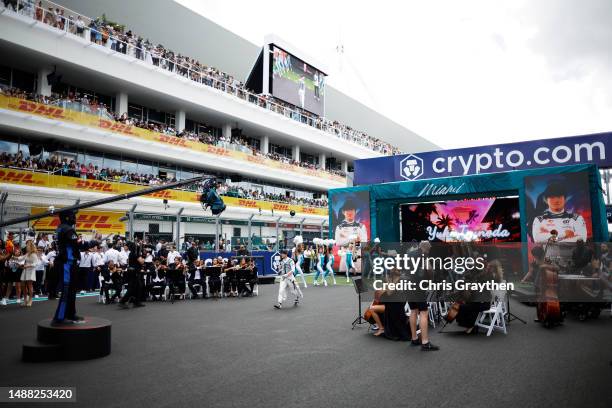 General view as Yuki Tsunoda of Japan and Scuderia AlphaTauri walks on the grid prior to the F1 Grand Prix of Miami at Miami International Autodrome...