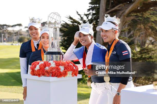 Ariya Jutanugarn, Moriya Jutanugarn, Patty Tavatanakit and Atthaya Thitikul of Team Thailand pose with the winners trophy after defeating Team...