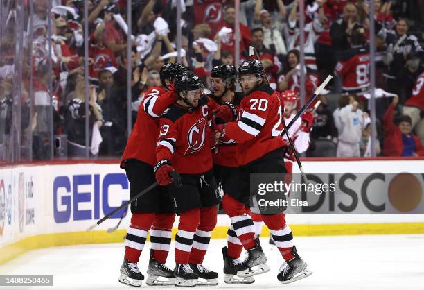 Michael McLeod of the New Jersey Devils is congratulated by teammates Brendan Smith,Nico Hischier and John Marino after McLeod scored a goal during...