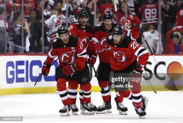 Michael McLeod of the New Jersey Devils is congratulated by teammates Brendan Smith,Nico Hischier and John Marino after McLeod scored a goal during...