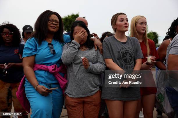 Therese Badiki, Adriana Rosales, Marley Hall, and Addie Bell stand together during a vigil next to a memorial next to the Allen Premium Outlets on...