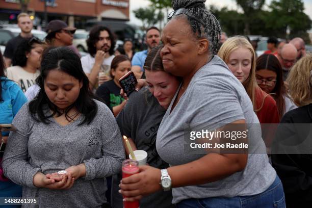 Tara williams hugs Marley Hall during a vigil at a memorial next to the Allen Premium Outlets on May 7, 2023 in Allen, Texas. The memorial is for the...